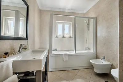 a bathroom with a sink and a shower and a toilet at Villa Das Oliveiras amazing location walk to Marina restaurants beach in Albufeira