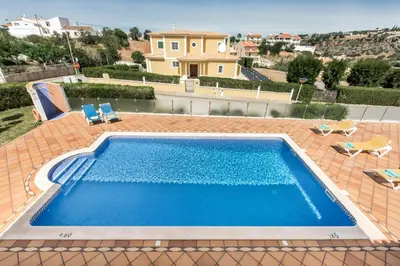 a swimming pool on top of a house at Villa Das Oliveiras amazing location walk to Marina restaurants beach in Albufeira