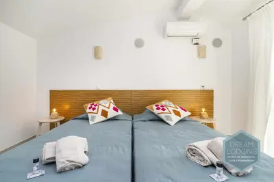a bedroom with a blue bed with towels on it at Villa Rafaella 3 - Dream Lodging in Albufeira