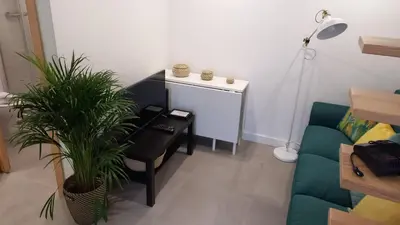 a living room with a couch and a table and a desk at CASA DAS MOURAS in Faro