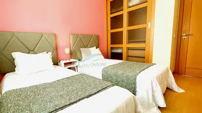 two beds sitting next to each other in a room at Garden Residence Premium by Sunny Deluxe in Albufeira