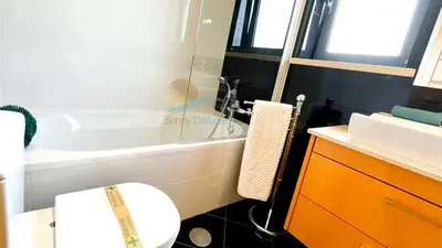 a bathroom with a toilet and a bath tub at Garden Residence Premium by Sunny Deluxe in Albufeira