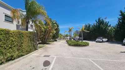 a street with cars parked in a parking lot at Garden Residence Premium by Sunny Deluxe in Albufeira