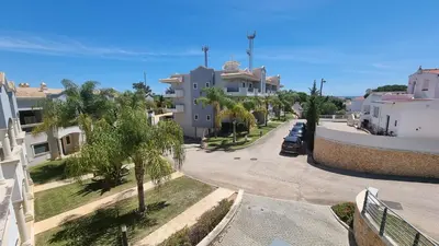 arial view of a street with palm trees and buildings at Garden Residence Premium by Sunny Deluxe in Albufeira