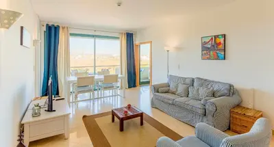 a living room with a couch and a table at Marina Vilamoura Aquamar 304 By Vilamoura Sun in Vilamoura