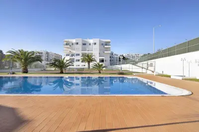a large swimming pool in front of a building at Apartamento Manelito House by Sunyway in Albufeira