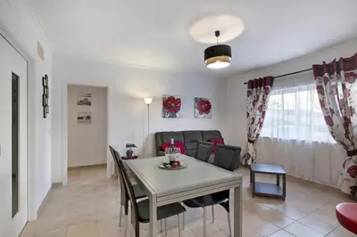 a living room with a table and a couch at Apartamento Manelito House by Sunyway in Albufeira