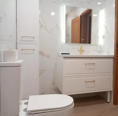 a white bathroom with a toilet and a sink at Apartamento Manelito House by Sunyway in Albufeira