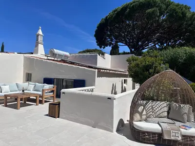 a bedroom with two beds and a mirror on the wall at Royal Course Villa, Vale do Lobo in Vale do Lobo