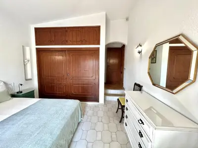 a bedroom with a bed and a mirror and a tub at Vila Santo Antonio - Vilamoura by HD PROPERTIES in Vilamoura