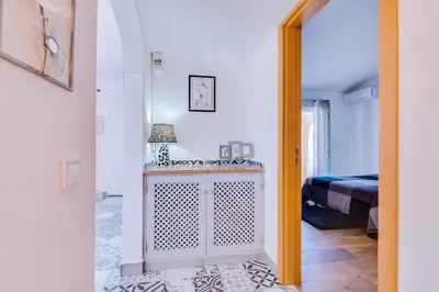 a room with a bed and a door leading to a bedroom at Villa Rimbaud in Albufeira