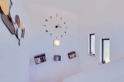 a clock on a wall with pictures on it at Villa Rimbaud in Albufeira