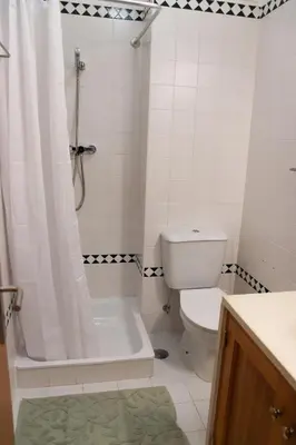 a bathroom with a tub and a toilet and a shower at Apartamento Salgados Mar in Albufeira