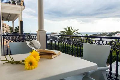 a table with a book and a sunflower on it at Oura Sunrise 3F Apartment by Stay ici Algarve Holiday Rental in Albufeira
