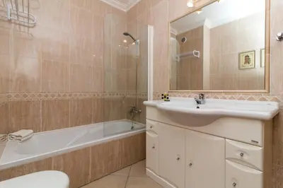 a bathroom with a sink and a tub and a toilet at Oura Sunrise 3F Apartment by Stay ici Algarve Holiday Rental in Albufeira