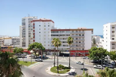 a street in a city with tall buildings at Quarteira Beach iii in Quarteira