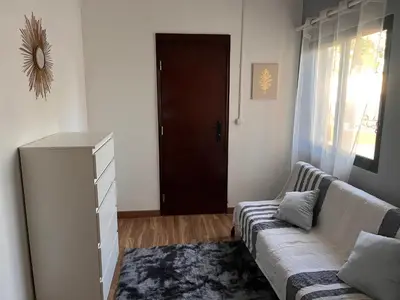 a living room with a couch and a door at Casa Amarela in Loulé