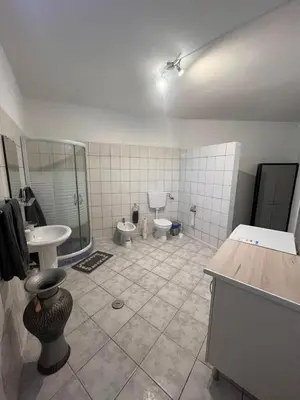a bathroom with two toilets and a shower and a sink at Casa Amarela in Loulé