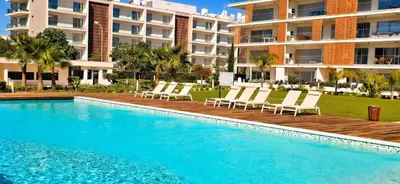 a swimming pool with lounge chairs next to a building at Marvell Design with heated pool&Playground in Albufeira