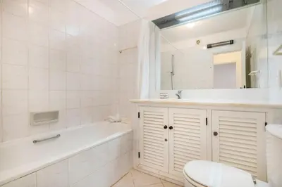 a white dining room with a white table and chairs at Albufeira Family Holidays @ Balaia 143 in Albufeira