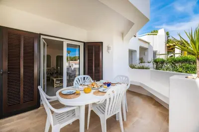 a bedroom with a bed and a toilet and a sink at Albufeira Family Holidays @ Balaia 143 in Albufeira