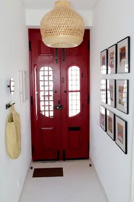 a red door in a hallway with a white floor at Arty Casa in Faro