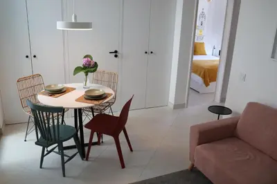 a living room with a table and chairs and a couch at Arty Casa in Faro