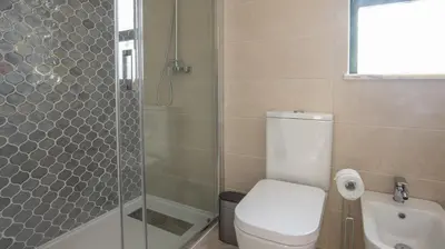 a bathroom with a toilet and a glass shower at Villa O Sonho do Algarve - Private Swimming Pool - BY BEDZY in Albufeira