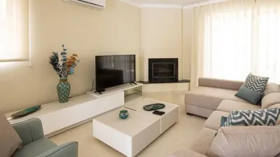 a living room with a couch and a tv at Villa O Sonho do Algarve - Private Swimming Pool - BY BEDZY in Albufeira