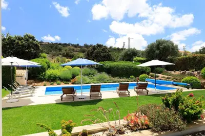 a bedroom with a bed and a television and a rug at Villa Isabella by OCvillas in Paderne