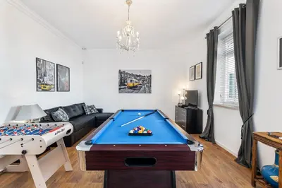 a living room with a pool table and a couch at Villa Isabella by OCvillas in Paderne