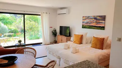 a living room with two beds and a television at Apartment São Rafael 63 - Beach - Pool - Free wi-fi - Air Con in Albufeira