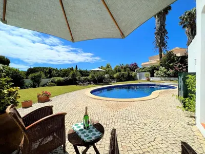 a patio with a pool and a table and chairs at Albufeira Balaia Villa With Private Pool by Homing in Albufeira