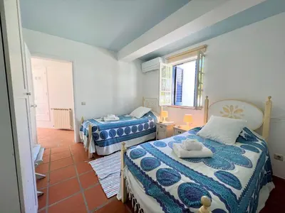 a bedroom with two beds and a window at Albufeira Balaia Villa With Private Pool by Homing in Albufeira