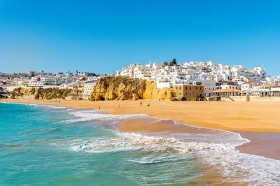 a view of a beach with buildings in the background at Albufeira Balaia Villa With Private Pool by Homing in Albufeira