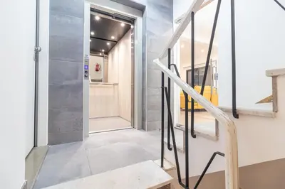 a hallway with a staircase and a glass door at Avenue 41 Guest House in Faro