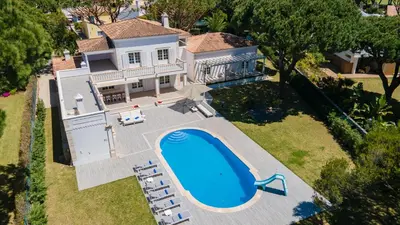 an aerial view of a house with a swimming pool at Portuguese mansion close to marina, golf and beach. in Vilamoura
