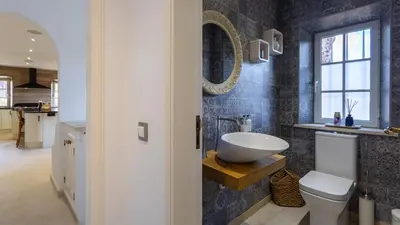 a bathroom with a sink and a toilet and a mirror at Portuguese mansion close to marina, golf and beach. in Vilamoura