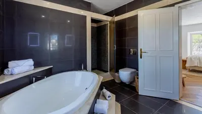 a bathroom with a bath tub and a toilet at Portuguese mansion close to marina, golf and beach. in Vilamoura