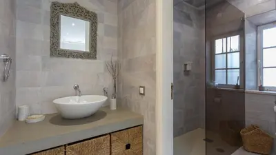 a bathroom with a sink and a mirror and a shower at Portuguese mansion close to marina, golf and beach. in Vilamoura