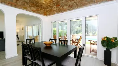 a dining room with a black table and chairs at Vila Renascer-CleverDetails, few minutes from the center, quiet area in Vilamoura