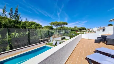 a patio with a swimming pool and a fence at Vila Renascer-CleverDetails, few minutes from the center, quiet area in Vilamoura