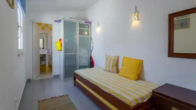 a small bedroom with a bed and a shower at Sea 3BDR House W/ Patio by Lovelystay in Albufeira