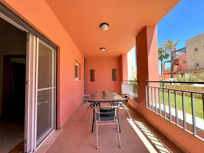 a balcony with a table and chairs on it at Vilamoura Victoria Gardens With Pool by Homing in Vilamoura