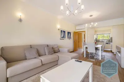 a living room with a couch and a table at Jardins da Marina - Dream Lodging in Albufeira