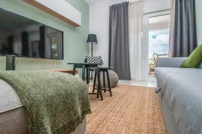 a living room with a couch and a table and a window at Apartment close to golf, beaches, Quinta Lago, Vale Lobo, Quarteira and Vilamoura in Quinta do Lago