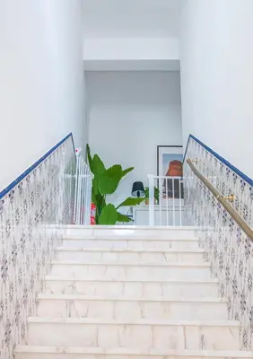 a staircase with white stairs and blue and white walls at Apartment close to golf, beaches, Quinta Lago, Vale Lobo, Quarteira and Vilamoura in Quinta do Lago
