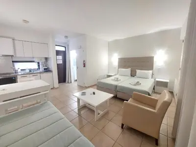 a bedroom with a bed and a living room at A CASA da PRAIA ALBUFEIRA PORTUGAL in Albufeira
