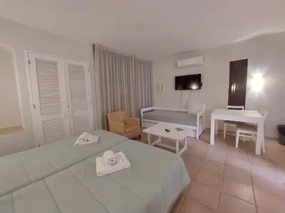 a hotel room with two beds and a table at A CASA da PRAIA ALBUFEIRA PORTUGAL in Albufeira