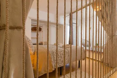 a bedroom with a metal bed in a room at Downtown & Beach in Albufeira
